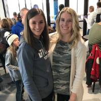 two attendees pose for a picture